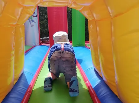 A child crawling through an inflatable tunnel